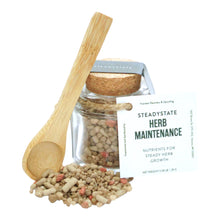 Load image into Gallery viewer, Herb maintenance fertilizer in a 1 oz glass jar with cork lid and bamboo spoon 
